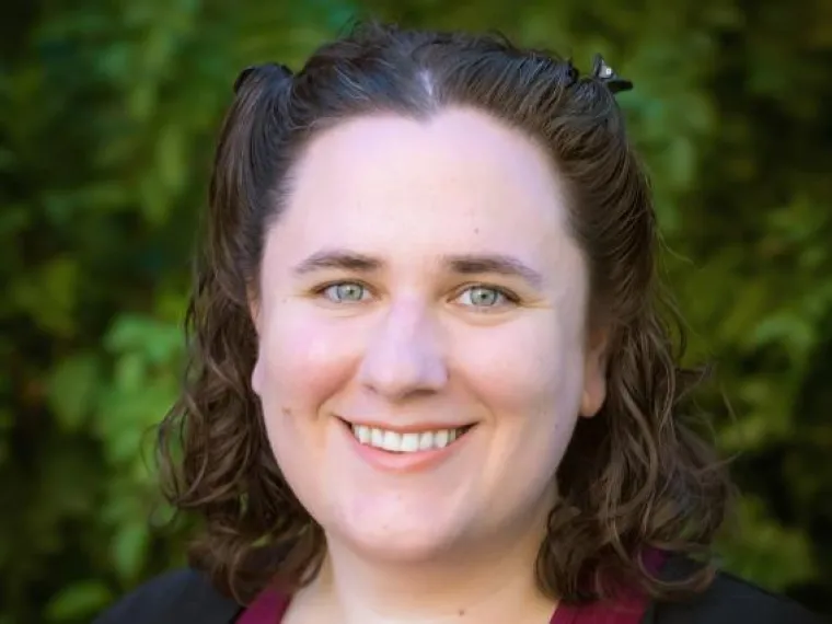 Portrait of a female with a green background. 